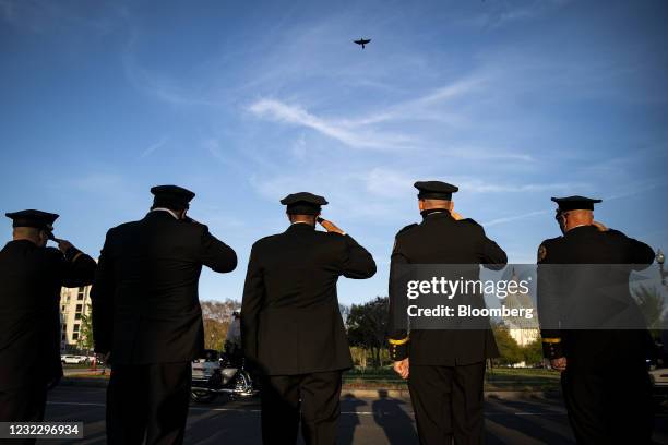 Members of the U.S. Secret Service salute during a procession carrying the casket of U.S. Capitol Police Officer William "Billy" Evans as it departs...