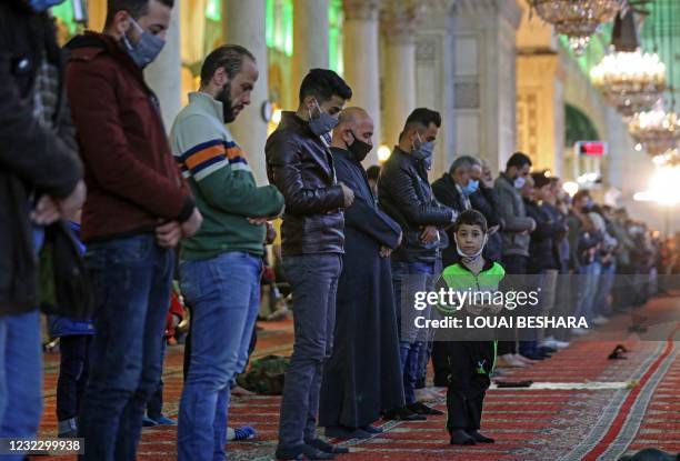 Syrians perform the evening Tarawih prayer during the holy month of Ramadan, at the Umayyad Mosque in the Syrian capital Damascus, on April 13, 2021.