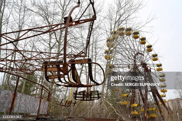 Picture taken on April 13, 2021 shows a ferris wheel in an abandoned amusement park in the ghost town of Pripyat near the Chernobyl Nuclear Power...