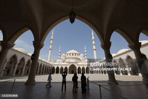 People visit the Sheikh Zayed Mosque in the Gulf emirate of Fujair on April 14, 2021 on the second day of fast during the Muslim holy month of...