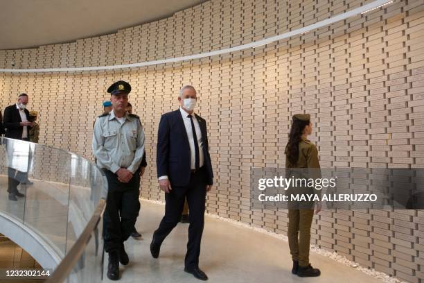 Israel's Defence Minister Benny Gantz walks along a path lined with bricks representing fallen service members at the National Hall For Israel's...