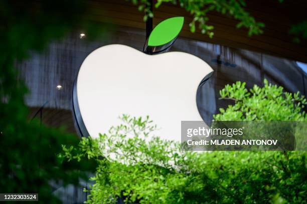 The Apple logo sporting a green leaf to mark the upcoming Earth Day is seen on a window of the company's store in Bangkok on April 14, 2021.