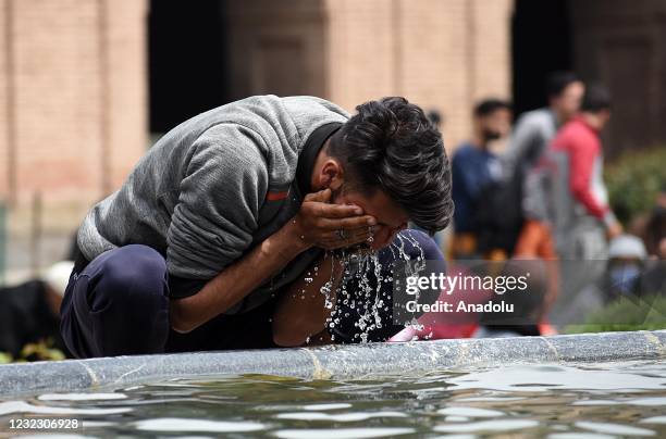 Man performs ablution before afternoon prayers on the first day of Ramadan in grand mosque in old city Srinagar,Kashmir on April 14, 2021.
