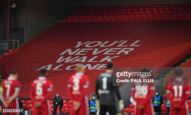 Liverpool players stand for a menute's silence on the eve of the 32nd anniversary of the Hillsborough football stadium disaster during the UEFA...