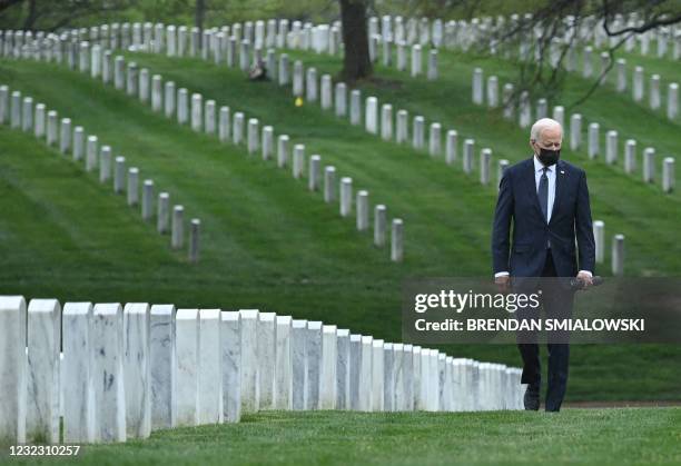 President Joe Biden walks through Arlington National cemetary to honor fallen veterans of the Afghan conflict in Arlington, Virginia on April 14,...