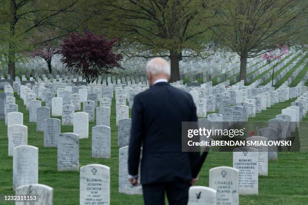 President Joe Biden walks through Arlington National cemetary to honor fallen veterans of the Afghan conflict in Arlington, Virginia on April 14,...