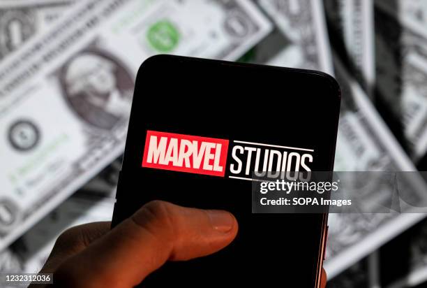 In this photo illustration, the American film production label owned by Disney, Marvel Studios, logo is seen on an Android mobile device screen with...