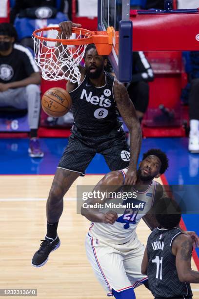 DeAndre Jordan of the Brooklyn Nets dunks the ball over Joel Embiid of the Philadelphia 76ers in the first quarter at the Wells Fargo Center on April...