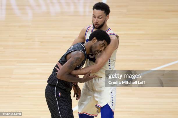 Ben Simmons of the Philadelphia 76ers guards Kyrie Irving of the Brooklyn Nets in the second quarter at the Wells Fargo Center on April 14, 2021 in...