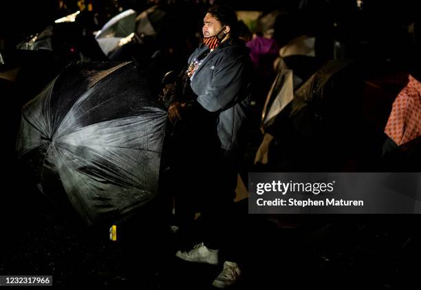 Person reacts after being pepper sprayed as protesters confront law enforcement outside the Brooklyn Center police headquarters on April 14, 2021 in...
