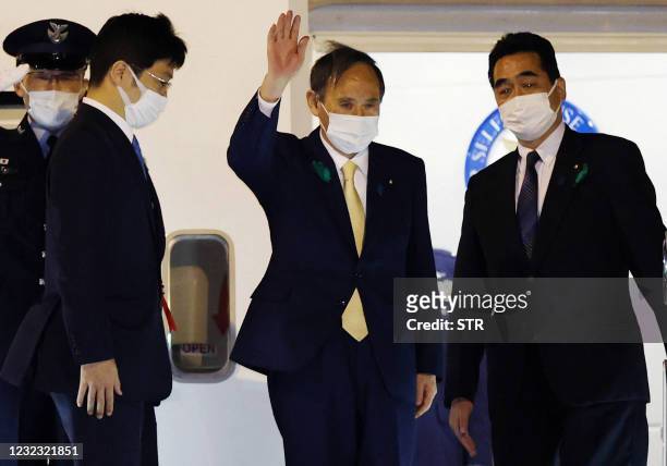 Japan's Prime Minister Yoshihide Suga waves as he departs for the US from Tokyo's Haneda airport on April 15, 2021 to become the first foreign leader...