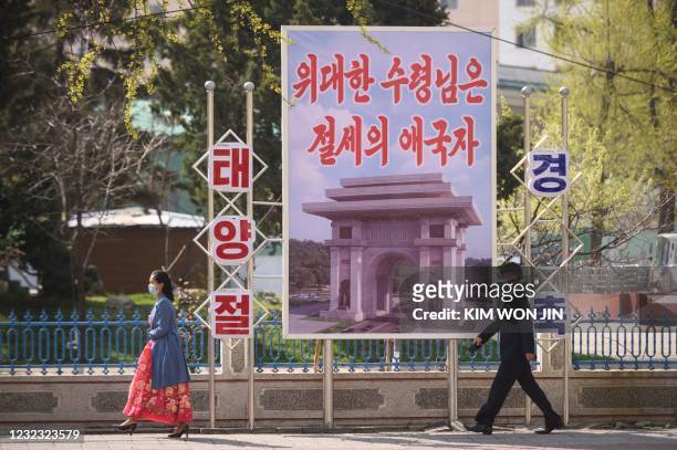 Propaganda poster reading "The great leader is a peerless patriot" is displayed on a street as North Korea marks the 109th birth anniversary of late...
