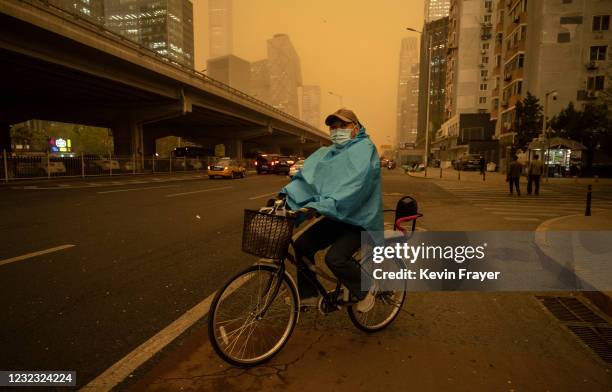 Man rides his bicycle during a seasonal sandstorm on April 15, 2021 in Beijing, China. China's capital and the northern part of the country typically...