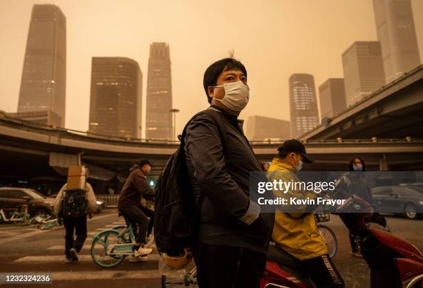 Commuter wears a protective mask as they wait at a traffic light during a seasonal sandstorm on April 15, 2021 in the Central Business District in...