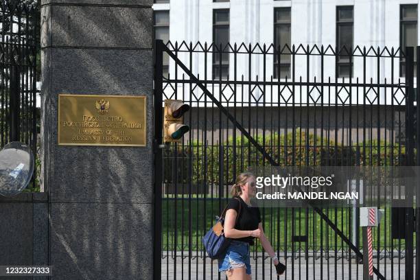 Pedestrian is seen in front of the Embassy of Russia in Washington, DC on April 15, 2021. - The US announced sanctions against Russia on April 15 and...