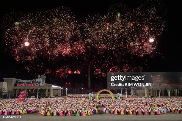 Students and young participants dance during an evening gala and fireworks event marking the birth anniversary of late North Korean leader Kim Il...