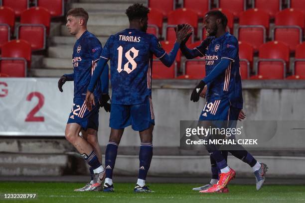 Arsenal's French-born Ivorian midfielder Nicolas Pepe celebrates scoring with his team-mate Arsenal's Ghanaian midfielder Thomas Partey during the...