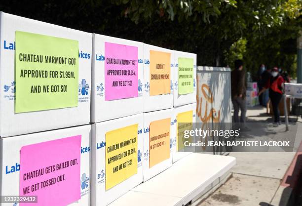 Protest signs are seen on boxes during a food distribution and protest in front of Chateau Marmont in Los Angeles, California, on April 15 as the...