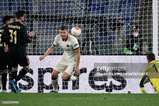 Roma's Bosnian forward Edin Dzeko celebrates after scoring an equalizer past Ajax Dutch goalkeeper Maarten Stekelenburg during the UEFA Europa League...