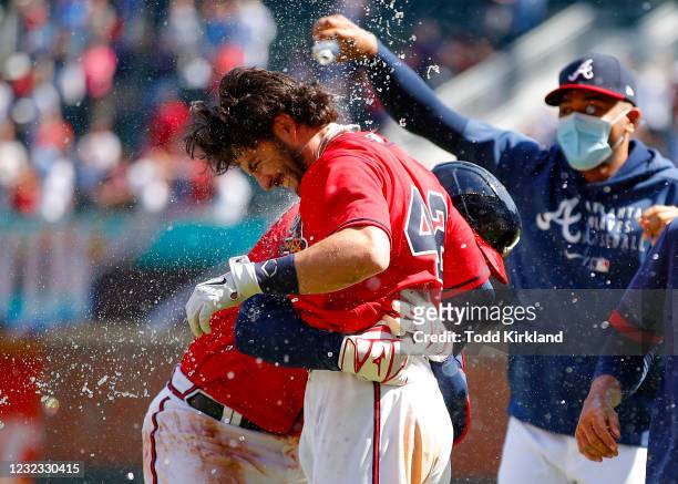 Austin Riley reacts with Dansby Swanson of the Atlanta Braves after Swanson's game winning single in the ninth inning of an MLB game against the...