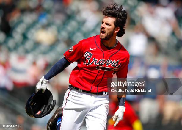Dansby Swanson of the Atlanta Braves reacts after hitting a walk off, game winning single in the ninth inning of an MLB game against the Miami...