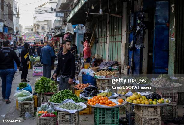 Palestinian sells vegetables at a market during the holy month of Ramadan in Gaza City.