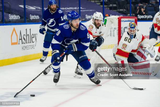 Tyler Johnson of the Tampa Bay Lightning skates against Keith Yandle and goalie Chris Driedger of the Florida Panthers during the first period at...