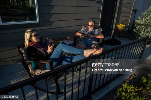 Bree McDowel, left, and Bill Van Heusen, right, enjoy the sunset from their patio at The Row, a new apartment development on Tuesday, March 23, 2021...