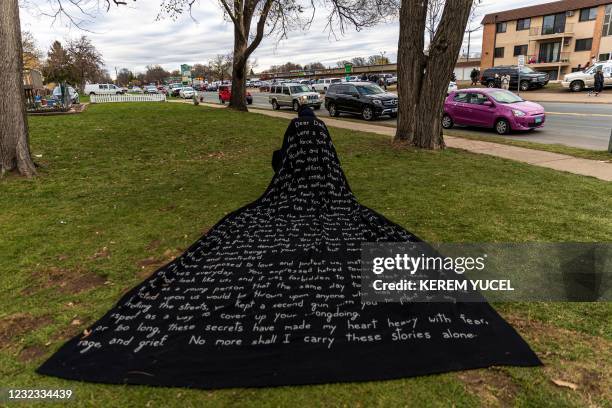 San Francisco-based artist Liney D draws attention to social injustice by wearing a cape with her story written on it, in front of the Brooklyn...