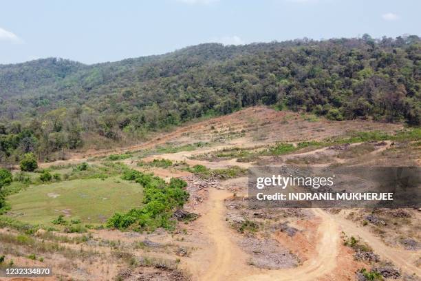 In this aerial photograph taken on march 11, 2021 a stretch of barren land next to remaining greenery is seen at a project site in the Mollem...