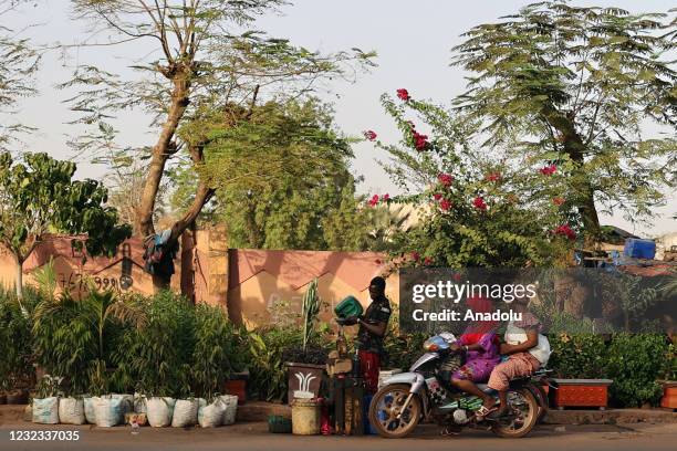 Two women on motorcycle a street of Bamako, Mali on April 13, 2021. Among the 25 poorest countries in the world, Mali depends on gold mining and...