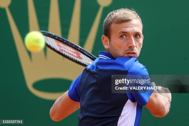 Britain's Daniel Evans looks at the ball during his quarter final singles match against Belgium's David Goffin on day seven of the Monte-Carlo ATP...