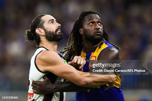 Brodie Grundy of the Magpies competes a throw-in with Nic Naitanui of the Eagles during the 2021 AFL Round 05 match between the West Coast Eagles and...