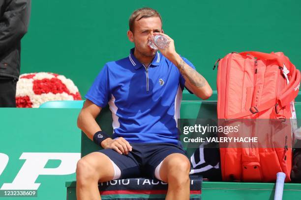 Britain's Daniel Evans sits during a break in his quarter final singles match against Belgium's David Goffin on day seven of the Monte-Carlo ATP...