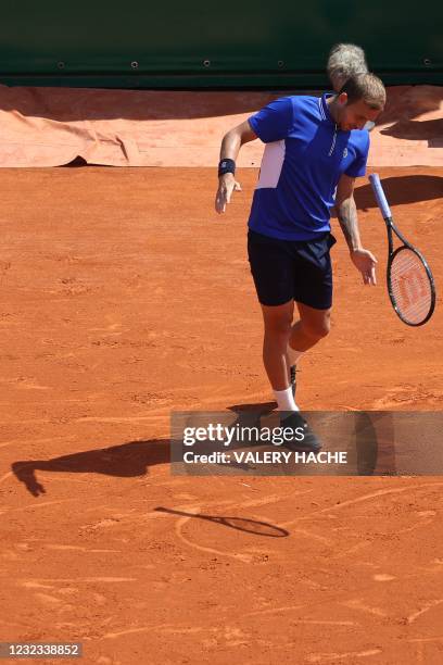 Britain's Daniel Evans throws his racket during his quarter final singles match against Belgium's David Goffin on day seven of the Monte-Carlo ATP...