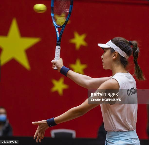 China's Xinyu Wang returns the ball to Dutch tennisplayer Kiki Bertens during the Billie Jean King Cup tennis Play-off in Den Bosch on April 16,...