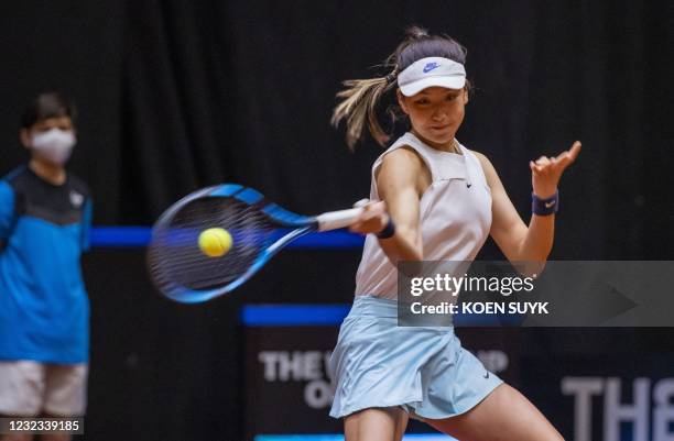 China's Xinyu Wang returns the ball to Dutch tennisplayer Kiki Bertens during the Billie Jean King Cup tennis Play-off in Den Bosch on April 16,...