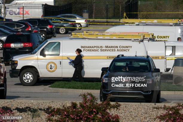 Marion County Forensic Services vehicles are parked at the site of a mass shooting at a FedEx facility in Indianapolis, Indiana on April 16, 2021. -...