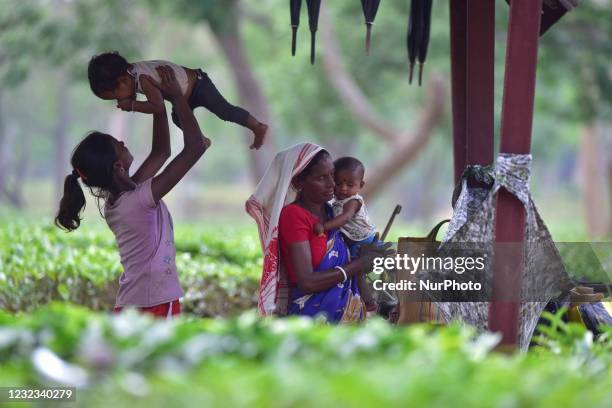 An Indian tea plantation worker seen playing with her child at a tea garden in Nagaon district, in the northeastern state of Assam, India on April...