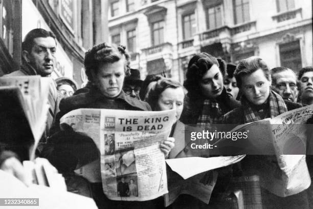 Serious faces of crowd in London reading news of King's George VI death in newspapers on February 6, 1952.