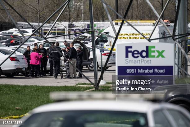 Group of crime scene investigators gather to speak in the parking lot of a FedEx SmartPost on April 16, 2021 in Indianapolis, Indiana. The area is...
