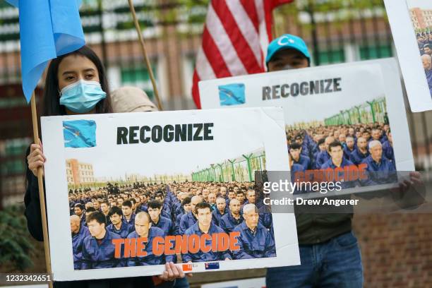 Supporters of the East Turkistan National Awakening Movement rally in front of the British Embassy ahead of an April 22 vote in the British House of...