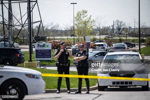 Police officers stand behind caution tape near a crime scene on April 16, 2021 in Indianapolis, Indiana. The area is the scene of a mass shooting at...