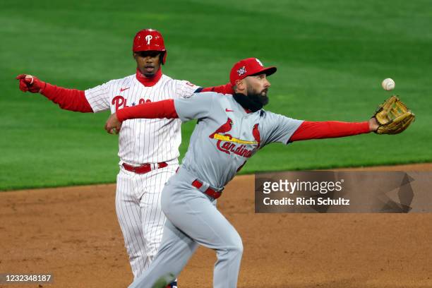 Jean Segura of the Philadelphia Phillies reacts after hitting an RBI double as second baseman Matt Carpenter of the St. Louis Cardinals bobbles the...
