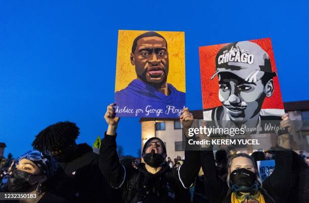 Demonstrators hold George Floyd and Daunte Wright's portraits, both shot and killed by police officers, outside the Brooklyn Center Police Department...