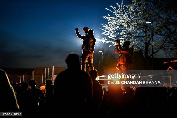 Demonstrators shout slogans outside the Brooklyn Center police station during the sixth night of protests over the shooting death of Daunte Wright by...