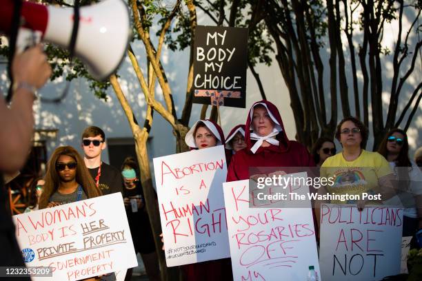 People participate in a protest against HB314, which would ban abortions in all cases except the health of the mother, outside the Alabama State...