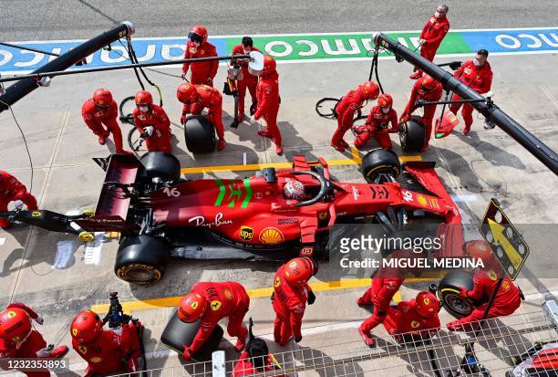 Ferrari mechanics work on the car of Ferrari's Monegasque driver Charles Leclerc in the pit lane during a practice session at the Autodromo...