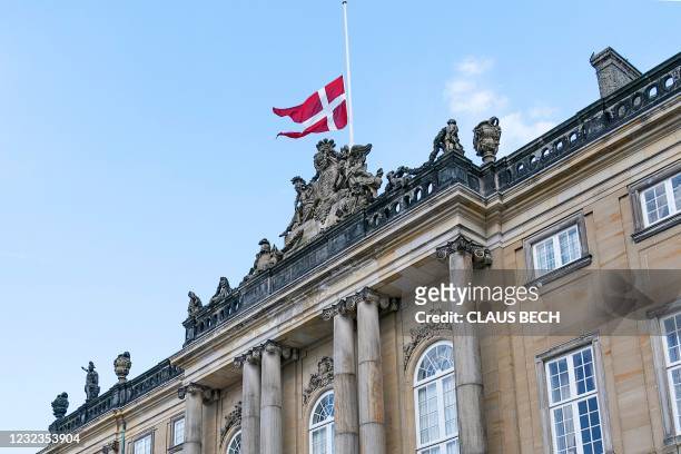 The Danish national flag flies at half mast at Amalienborg Palace in Copenhagen on April 17 on the occasion of the funeral of Britain's Prince...