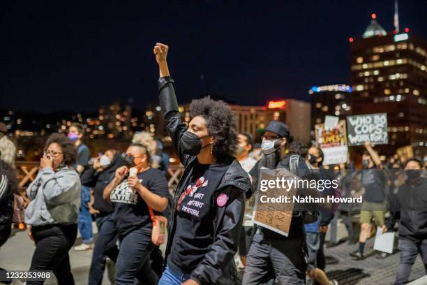 Protesters March along the Hawthorne Bridge following the police shooting of a homeless man in Lents Park on April 16, 2021 in Portland, Oregon. The...